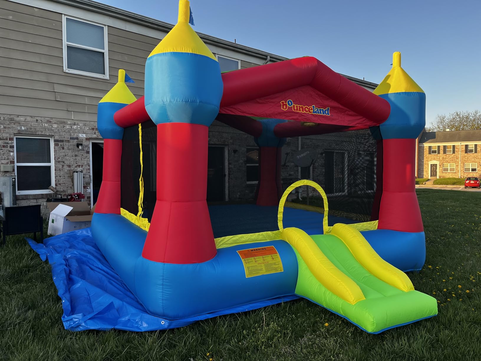 Bounceland Inflatable Party Castle Bounce House Bouncer, 16 ft L x 13 ft W x 10.3 ft H, Basketball Hoop, Removable Sun Roof, UL Strong Blower included, Fun Slide and Bounce Area, Castle Theme for Kids customer photo 1